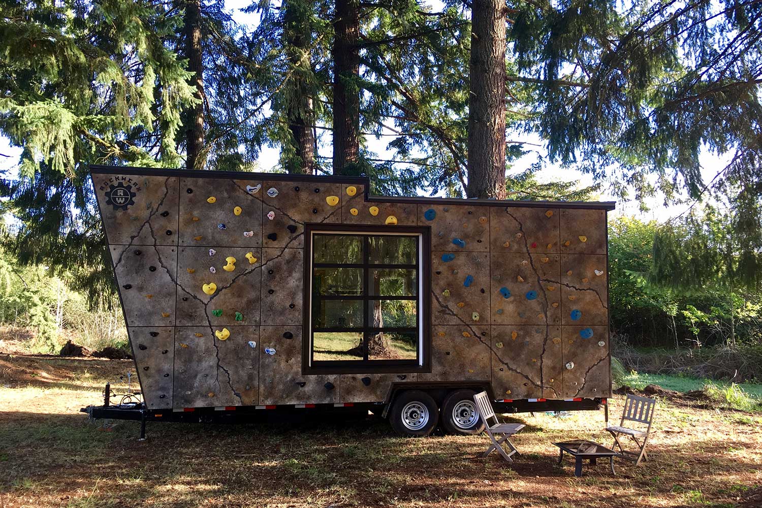 Outside view of the Tiny Adventure Home which features a climbing wall on the exterior