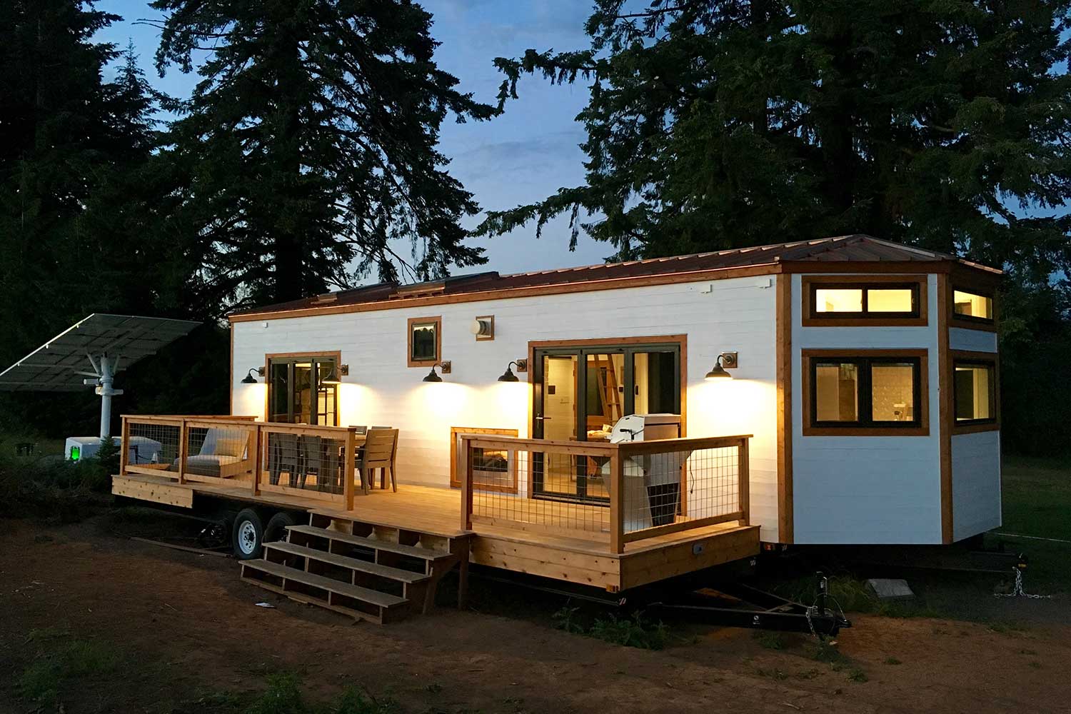 Hawaiian Retreat custom tiny home outside night view with light up inviting porch