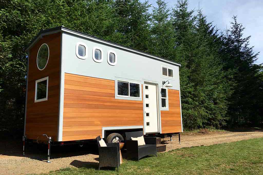 Outside view of the High-Flying Tiny Home with forest in the backgroubd