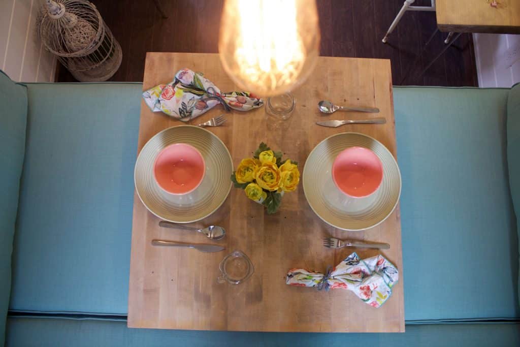 Overhead view of set table in the dining area of the Southern Charm custom tiny house