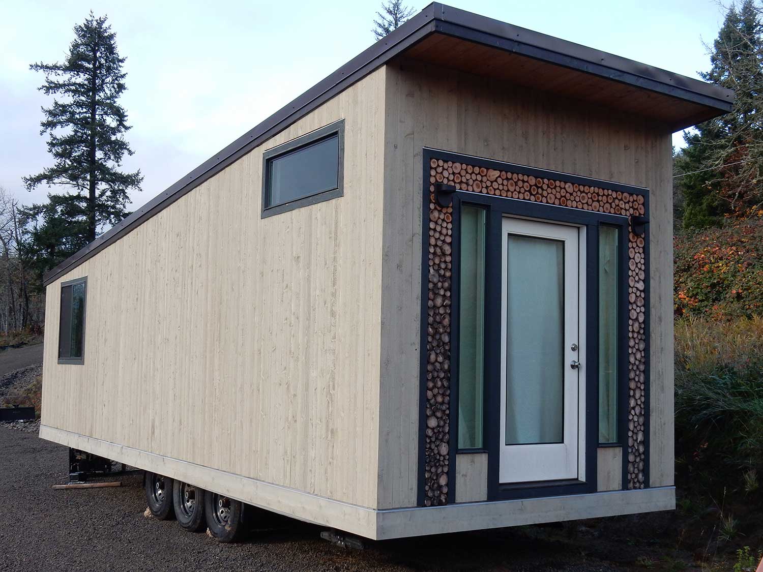 Outside view of the front door of the Log Cabin tiny home custom built by TIny Heirloom