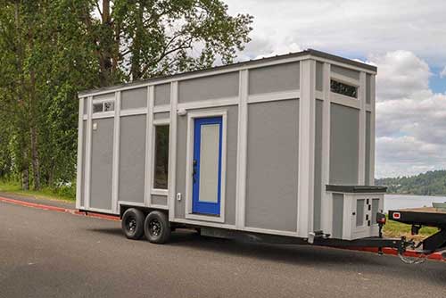 Outside view of gray custom tiny house