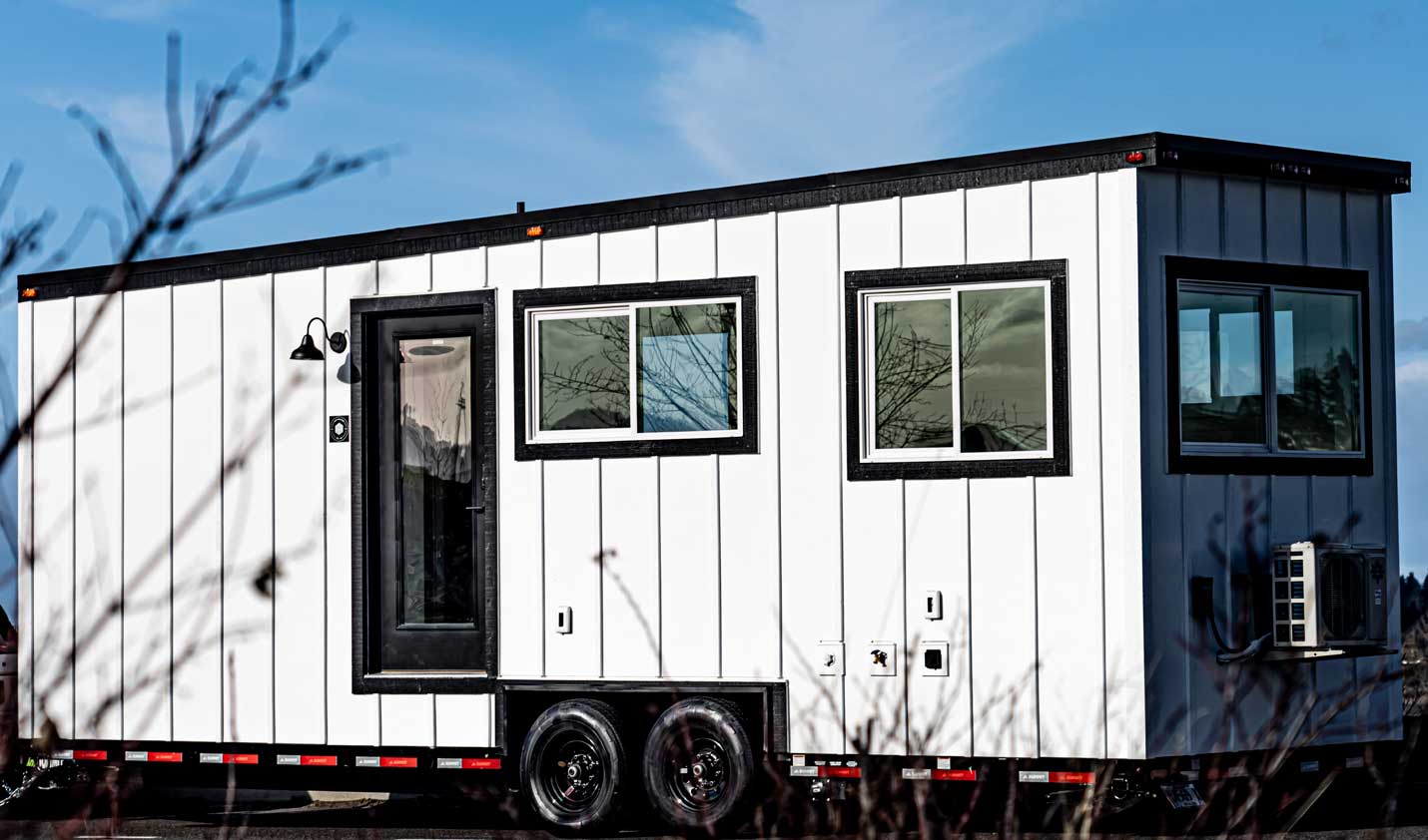 Legacy tiny house outside shot, farmhouse style in white